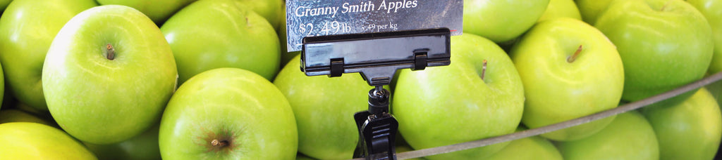 Apple display in produce section with a TwistKlip sign holder