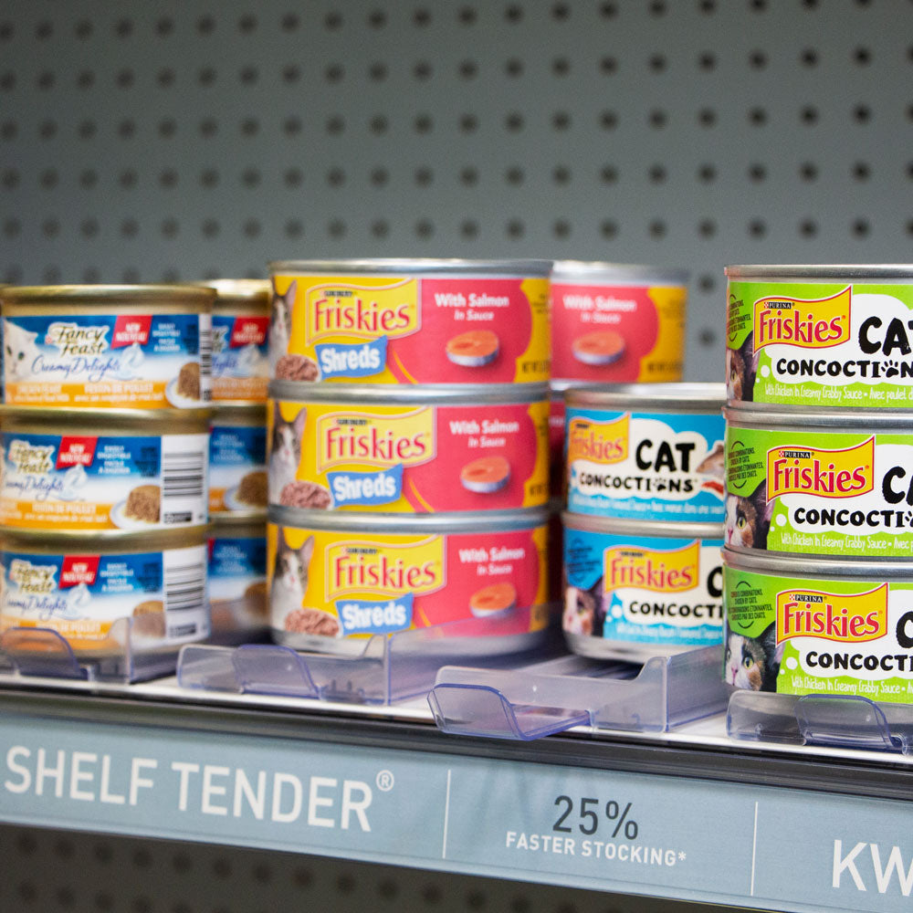 A shelf with stacked cans of cat food on top of medium Shelf Tenders to keep them organized