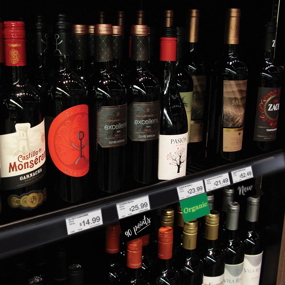 Liquor store wine shelf with ClearGrip ticket molding and ShelfTalkers.