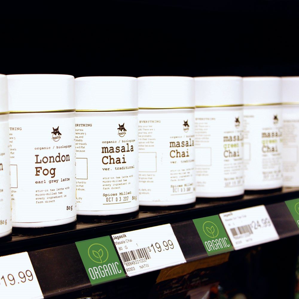A grocery store shelf edge displaying teas with a ClearVision ticket molding and "Organic" ChipTalkers