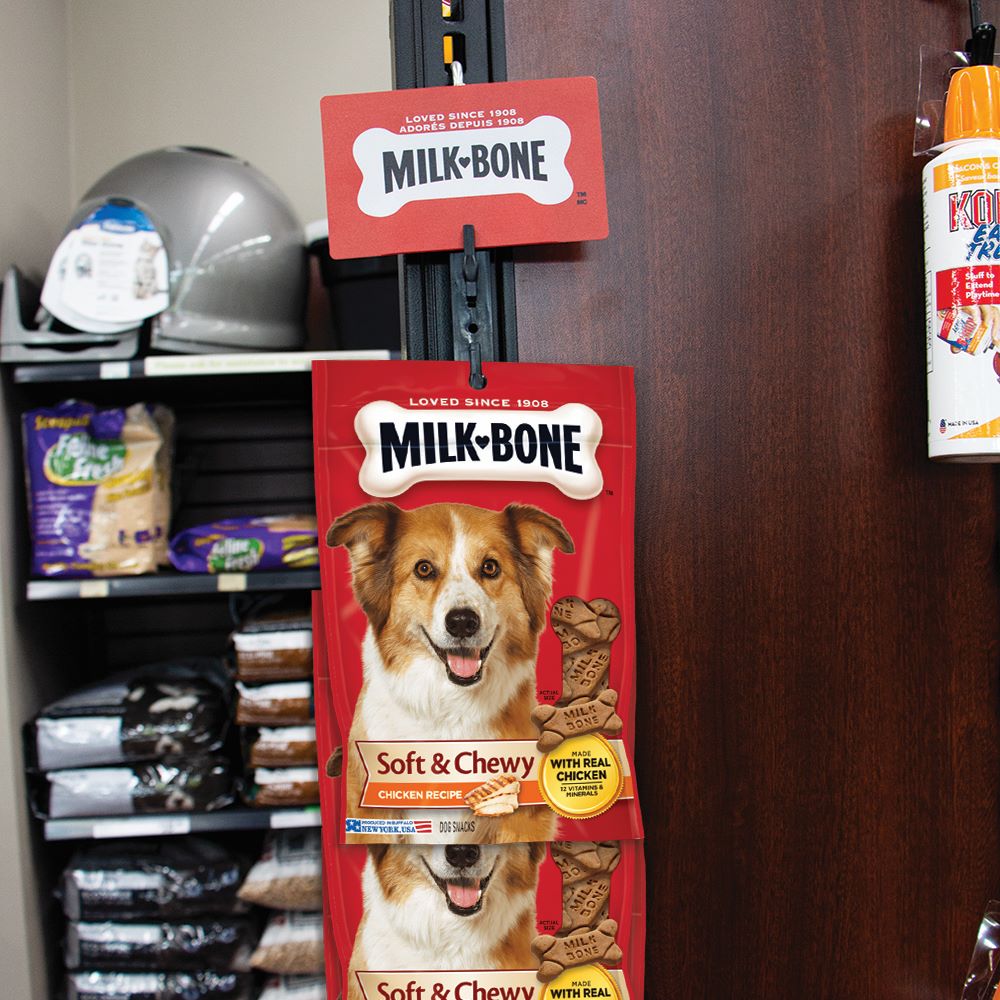 The Merchandise Strip, 12 Clips with Label Holder holding bags of dog treats in a pet store