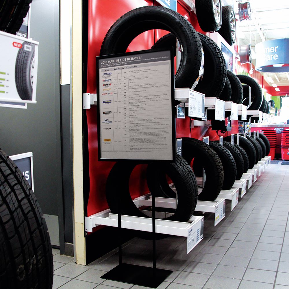 An economy indoor WalkTalker in the tire section of an automotive section of a store