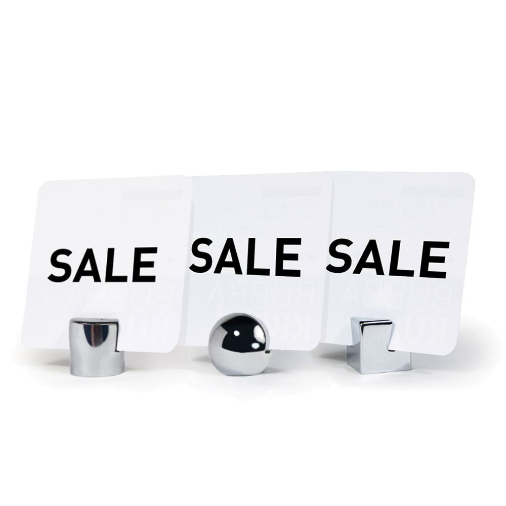 The cyninder, sphere and cube Stainless Steel Sign Holders side by side holding "sale" signs