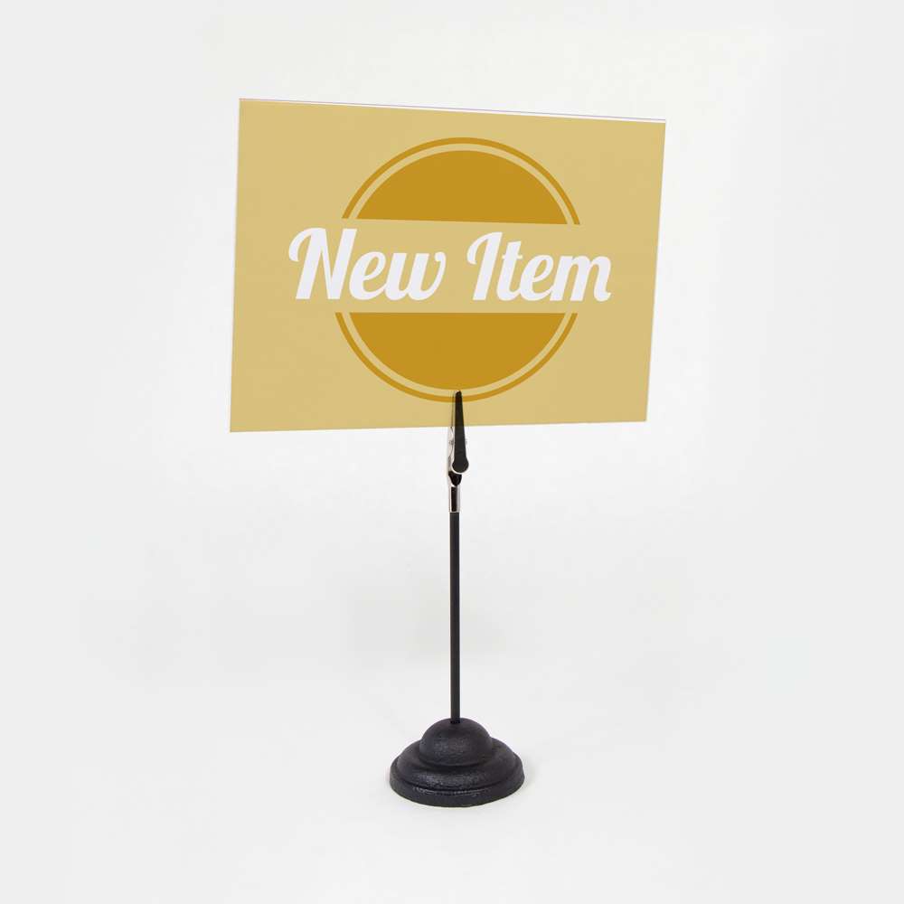 The 6" AlliKlip Straight Wire, Contour Base Sign Holder holding a sign.